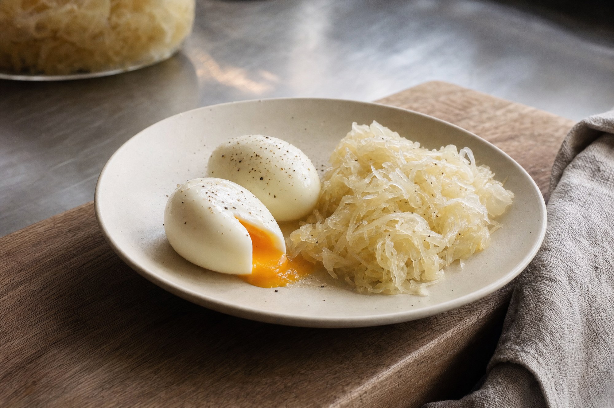 Soft eggs and sauerkraut on a ceramic plate in morning light